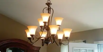 Classic ceiling chandelier installation with warm lighting in Redding, CA
