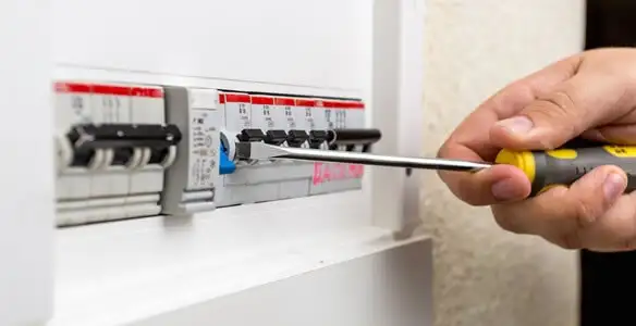 electrical panel upgrade service showing technician adjusting circuit breakers during system upgrade in Redding, CA