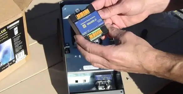 Electrician installing whole home surge protection unit inside main electrical panel in Redding, CA