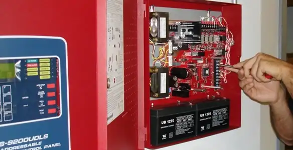fire alarm installation service showing technician configuring fire alarm control panel in Redding, CA