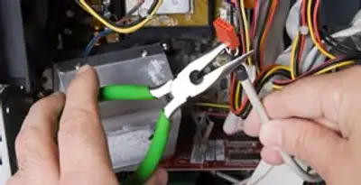 Licensed electrical contractor performing electrical repair with tools in French Gulch, CA
