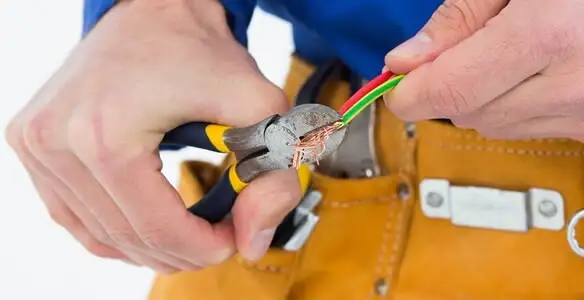 licensed electrician securing electrical wiring with professional tools during service work in Redding, CA