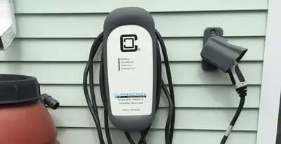 Outdoor electric vehicle charger installation on residential wall in Redding, CA